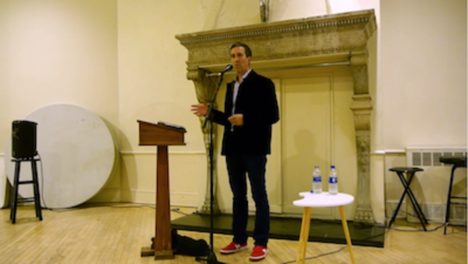 Vincent Katz reading in front of a podium at St. Mark's Church